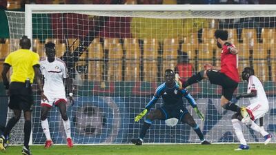 Sudan goalkeeper Ali Abou Achrine watches on as Egypt's Mohamed Salah shoots at goal. AP Photo
