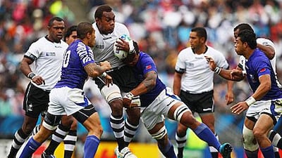 Tusi Pisi and George Stowers, the Samoan tacklers, stop the Fijian Leone Nakarawa in his tracks during their Pool D match at the Rugby World Cup.