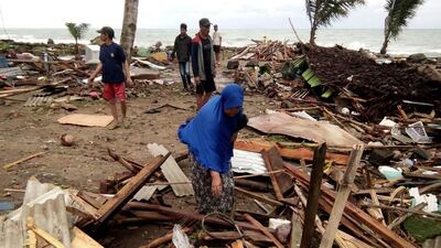 Residents inspect the damage to their homes on Carita beach. AFP