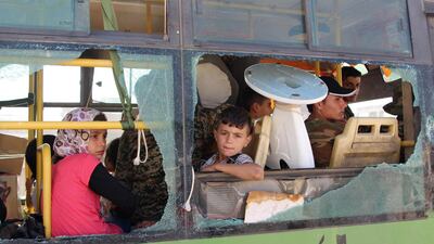 Syrians are evacuated by bus from the pro-regime towns of Fuaa and Kafraya in Idlib province on July 19, 2018. AFP