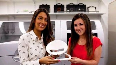 Sarah Alagroobi, left, and Noor Jarrah with a model of Ms Alagroobi's design.