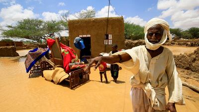 A Sudanese man stands next to his furniture after torrential rain lead to landslides and flash floods in the town of Umm Dawan Ban, southeast of Khartoum on August 2, 2020. Ashraf Shazly / AFP
