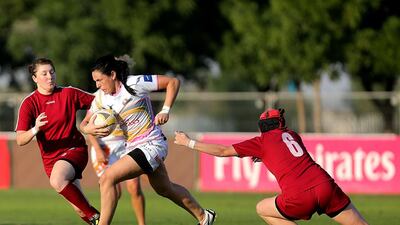 Dubai Hurricanes women's team, in white, ran pust the Russian team Burevestnik Kuzbass on their way to the international open title. Satish Kumar / The National