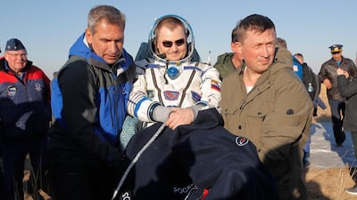 Russian space agency rescue team members and United Arab Emirates specialists carry Maj Al Mansouri. AP Photo