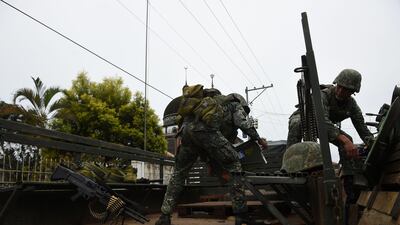 Philippine marines load ammunition onto an armoured personnel carrier at the frontline in Marawi on July 22, 2017. Ted Aljibe / AFP
