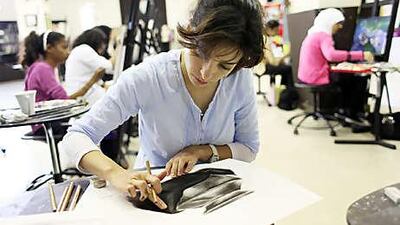 Diana Darouiche works on a charcoal drawing during one of a recent Art Workshop classes at the National Theatre in Abu Dhabi.