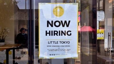 A 'Now Hiring' sign is posted in front of an ice-cream shop in Los Angeles, California, as reports show companies boosted hiring in May. AFP