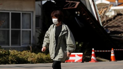 A woman walks near flooded houses, in the aftermath of Typhoon Hagibis, in Koriyama, Fukushima prefecture, Japan. REUTERS