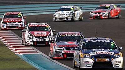 V8 Supercars vie for the lead at at the Yas Marina Circuit last night.