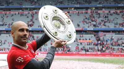 Bayern Munich's Spanish coach Pep Guardiola holding the trophy as they celebrate winning their 25th Bundesliga title after the German first division Bundesliga football match FC Bayern Munich vs 1 FSV Mainz 05 at the Allianz Arena in Munich, southern Germany on May 23, 2015. Pep Guardiola will leave Bayern Munich as head coach at the end of the season and be replaced by Carlos Ancelotti, the club states on Decmber 20, Christof Stache / AFP