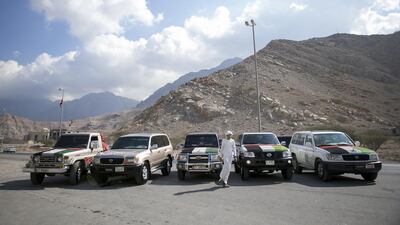 Ahmed Huraiz makes a final check on his friends’ cars before heading out from Wadi Shaam to Ras Al Khaimah’s corniche. Reem Mohammed / The National