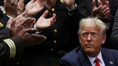 US President Donald Trump listens to applause after signing an executive order on police reform during a ceremony in the Rose Garden at the White House in Washington. Reuters