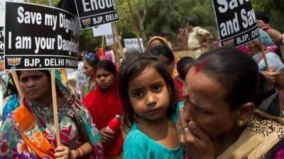 Distraught women from India's opposition Bharatiya Janata Party hold placards near the residence of ruling Congress Party president Sonia Gandhi following the rape of a five-year-old girl.
