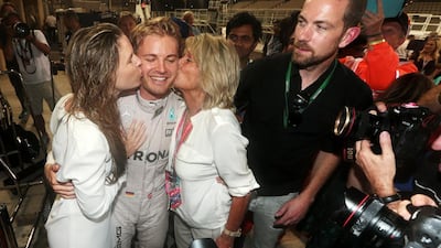 Nico Rosberg of Germany and Mercedes-GP receives kisses from his wife Vivian Sibold, left, and his mother Sina Rosberg. Christopher Pike / The National