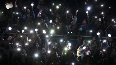 Fans light up the arena with their smartphones during a performance
