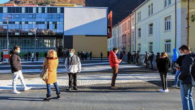 People line up outside a Covid testing facility set up at the Rosenbach Civic Center in the Oltrisarco district of Bolzano, South Tyrol. AFP
