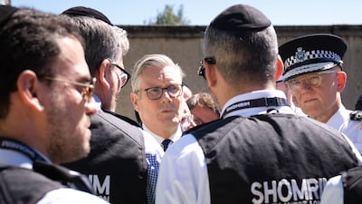 GOLDERS GREEN, ENGLAND - APRIL 30: Prime Minister Sir Keir Starmer (C) and Metropolitan Police Commissioner Sir Mark Rowley (R) meet first responders from Shomrim North West London during a visit to Golders Green on April 30, 2026 in Golders Green, England. A 45-year-old British-Somali man was arrested yesterday, after stabbing two Jewish men, Shloime Rand and Moshe Shine, in a terrorist attack in Golders Green. Both victims are in stable condition, and the suspect was caught by police after being tasered. The government has since pledged £25 million to improve security for the Jewish community following the incident. (Photo by Stefan Rousseau - WPA Pool / Getty Images)