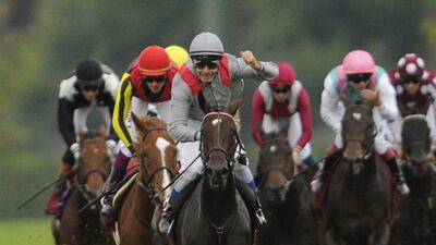 Jockey Thierry Jarnet, centre, ridingTreve celebrates after winning the Qatar Prix de l'Arc de Triomphe, on October 6, 2013 at Longchamp hippodrome in Paris. AFP PHOTO FRED DUFOUR