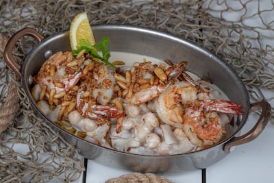 Pine nuts and fried garlic are scattered on top of fatteh shrimp. Photo: Ibn AlBahr