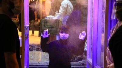 A young Iraqi is sprayed with disinfectant on his arrival to take part in a mourning ritual, as Shiite Muslims prepare to commemorate Ashura during the Islamic month of Muharram, in the central shrine city of Karbala. AFP