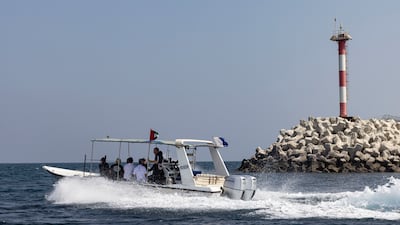 Divers and volunteers prepare to set up the new reef site. Antonie Robertson / The National