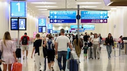 People arrive for their flights at Dubai International Airport. Chris Whiteoak / The National