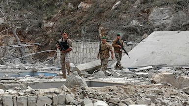 Lebanese soldiers inspect the site of an Israeli air strike in the southern village of Tair Felsay, near the Litani river, on Thursday. AFP
