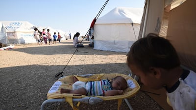A baby sleeps at a refugee camp in Nea Kavala, northern Greece. About 1,500 asylum-seekers transported from Greece's eastern Aegean island of Lesbos to the mainland. Around 1,000 of those transferred and housed in Nea Kavala, where they will be staying in tents until the end of the month, after which they will be transferred to a new camp under construction. AP