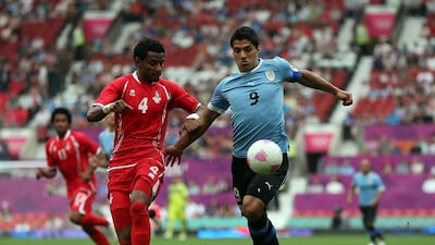 Luis Suarez of Uruguay battles with Mohamed Ahmad of the UAE. Getty Images