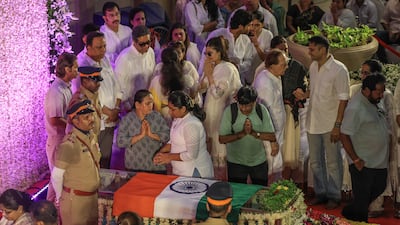 People gather to pay their respects to renowned Indian singer Asha Bhosle at her home in Mumbai, after her death at the age of 92. AP