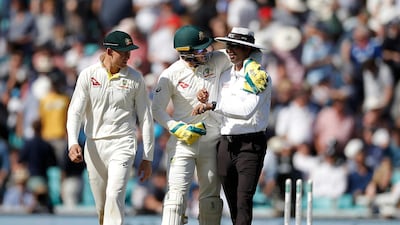Australia captain Tim Paine with his arm around Umpire Kumar Dharmasena as as the players head off for lunch at The Oval. Getty
