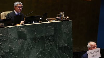 Palestinian UN envoy Riyad Mansour holds up a ceasefire sign at the UN on Tuesday. Reuters