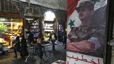 A picture of Syrian President Bashar al-Assad decorates the al-Buzuriya market in the Old City of the Syrian capital Damascus AFP
