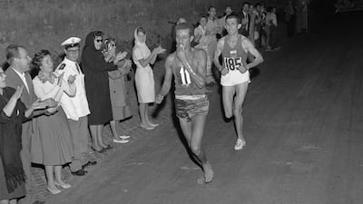 Ethiopian athlete Abebe Bikila running barefoot for victory during the Rome 1960 Olympic Games marathon, after passing Moroccan Abdeslam Radi. AFP Photo