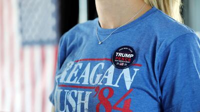 A vintage election T-shirt with a Trump/Pence pin on a supporter's shirt as people watch the results come in at Trump International Golf Club.