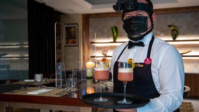 Host Joel Constantino offers welcome drinks and provides the briefing ahead of the Dining in the Dark experience. Victor Besa / The National