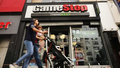 People pass a GameStop store in lower Manhattan in New York City. GameStop has announced that they will be closing between 180 and 200 stores before the end of the fiscal year due to a drop in sales. Getty Images/AFP.