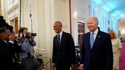 Mr Biden and Mr Obama arrive in the East Room of the White House for the unveiling. AP