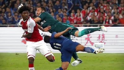 Chelsea's Pedro collides with Arsenal goalkeeper David Ospina. Mark Schiefelbein / AP Photo