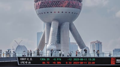 People walk on a pedestrian bridge with a screen showing stock exchange data in Shanghai. Saudi Arabia and China continue to strengthen economic ties. EPA