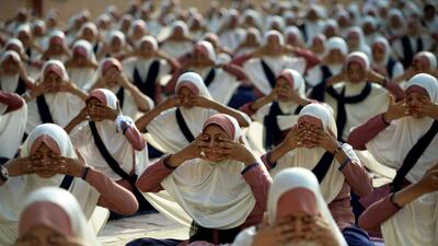 Indian school students attend a yoga workshop conducted by teachers from The Sri Sri Ravi Shankar Institute at The FD Higher Secondary School in Ahmedabad. Sam Panthaky / AFP