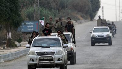 Turkey-backed Syrian rebel fighters ride on vehicles in the border town of Tal Abyad, Syria, October 16, 2019. REUTERS/Khalil Ashawi