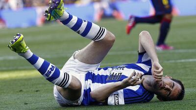 Real Sociedad defender Mikel Gonzalez reacts after falling on the ground during his side's La Liga loss to Barcelona on Saturday. Quique Garcia / AFP