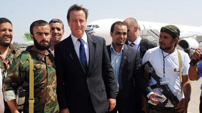 British Prime Minister David Cameron poses with Libyan rebels upon his arrival at Benghazi Airport on September 15, 2011, during a one-day visit to Libya with French President Nicolas Sarkozy. Mr Cameron and Mr Sarkozy spearheaded the Nato air campaign against Qaddafi, but a parliamentary committee savaged Mr cameron for the campaign . AFP PHOTO
