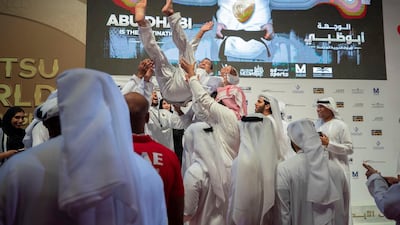 Faisal Al Ketbi is thrown up in the air by his fans after winning gold in the 94kg final at the JJIF World Championship at the Mubadala Arena on Friday. Courtesy Shivanna Gowda