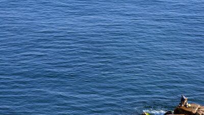A man fishes during a sunny day at the corniche al-Manara in Beirut, Lebanon. Wael Hamzeh / EPA