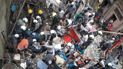 Rescue workers and residents search for survivors at the site of a collapsed building in Mumbai, India, on July 16, 2019. Reuters