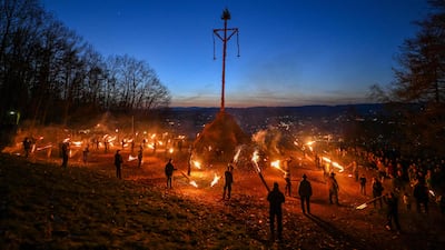 The Easter fire is lit with burning torches on a hill in Attendorn, western Germany. AFP