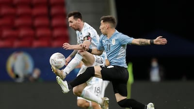 Lionel Messi in action with Uruguay's Fernando Gorriaran. Reuters