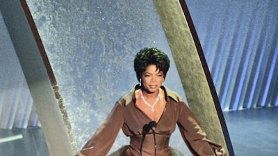Oprah Winfrey wears a brown silk gown with a taffeta train to attend the 67th Academy Awards in Los Angeles, California on March 27, 1995. FilmMagic